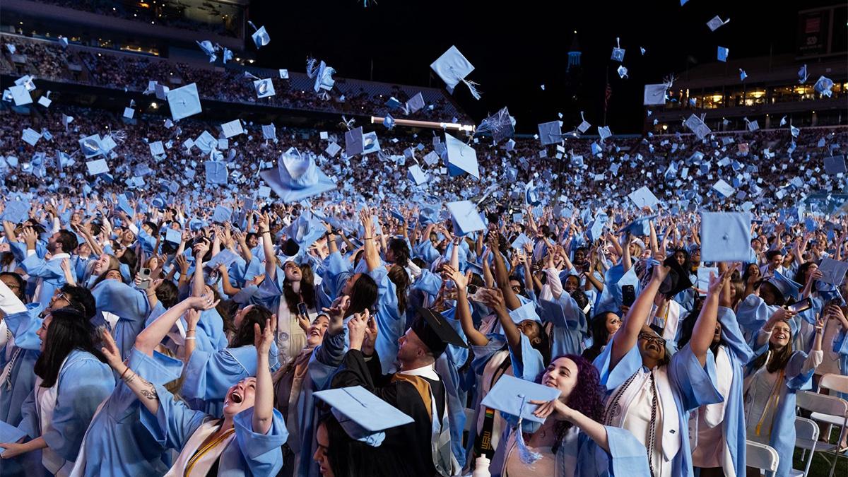 Students tossing caps at Commencement at Kenan Stadium